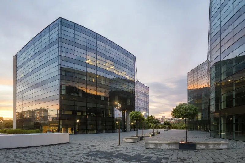 a couple of glass buildings sitting next to each other