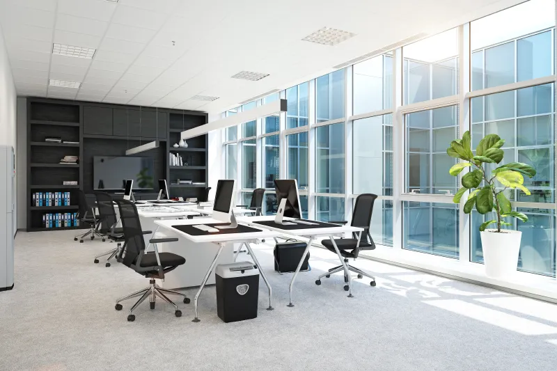 an office with a large window and a long table